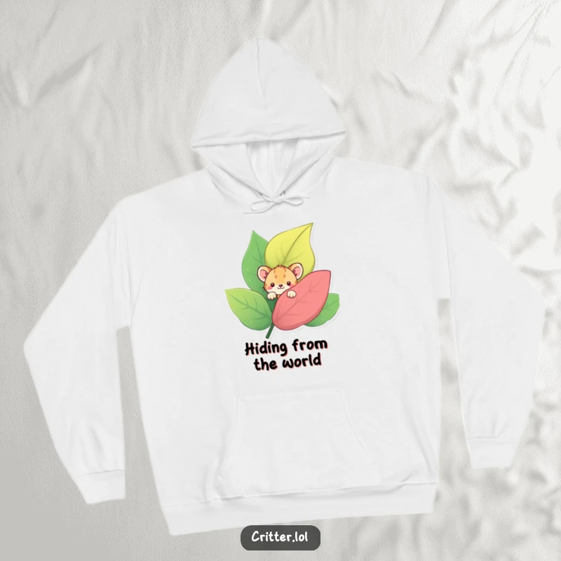 Funny hoodie featuring a shy critter peeking from behind a large, colorful leaf, ideal for cozying up with a touch of reserve.