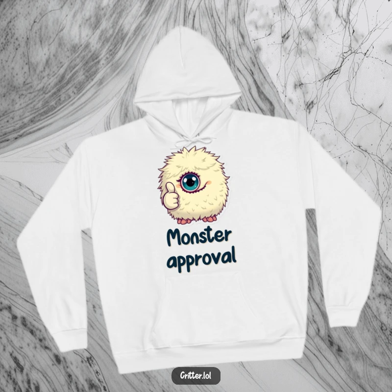 Funny hoodie featuring a tiny, fluffy, one-eyed monster giving a thumbs up, ideal for cozy and positive wear.
