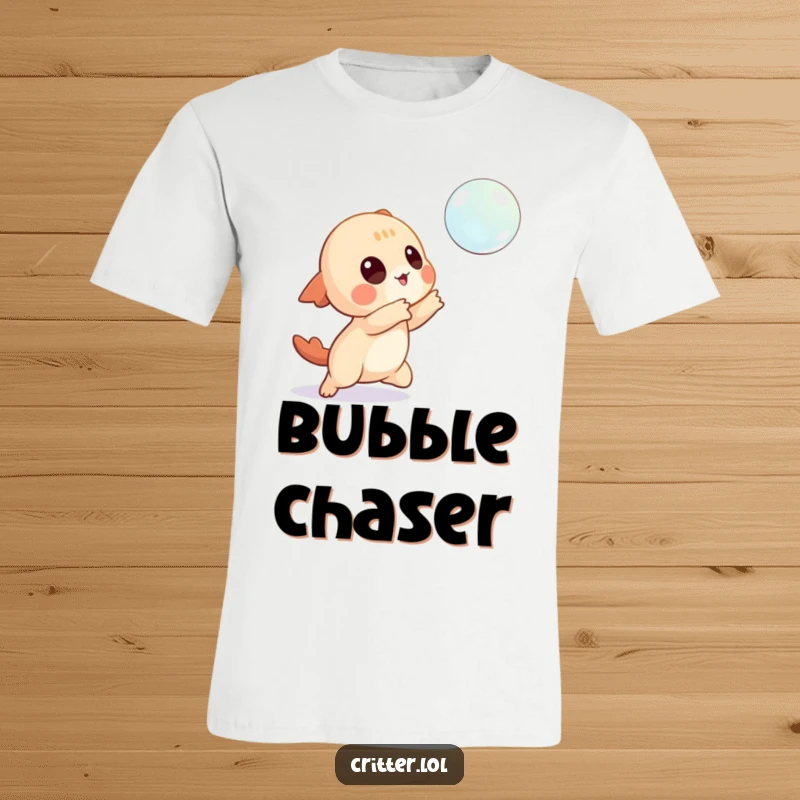 Funny t-shirt depicting a playful creature character actively trying to catch a shimmering, floating bubble.